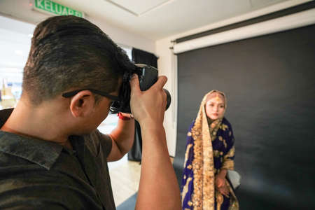 Kuala Lumpur, Malaysia â November 3, 2018: Group of photographers learning creative portrait during photo shooting in photography studio.のeditorial素材