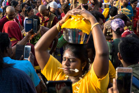 BATU CAVES, MALAYSIA - January 21, 2019: A celebration and devotee carrying kavadi preparing for ceremony prayers blessings during Thaipusam festival.のeditorial素材