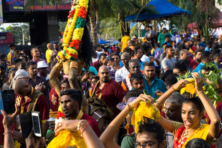 BATU CAVES, MALAYSIA - January 21, 2019: A celebration and devotee carrying kavadi preparing for ceremony prayers blessings during Thaipusam festival. Image contain certain grain or noise and soft focusのeditorial素材