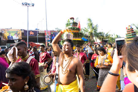 BATU CAVES, MALAYSIA - January 21, 2019: A celebration and devotee carrying kavadi preparing for ceremony prayers blessings during Thaipusam festival.のeditorial素材