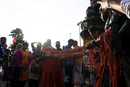 BATU CAVES, MALAYSIA - January 21, 2019: A celebration and devotee carrying kavadi preparing for ceremony prayers blessings during Thaipusam festival.のeditorial素材