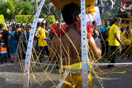 BATU CAVES, MALAYSIA - January 21, 2019: A celebration and devotee carrying kavadi preparing for ceremony prayers blessings during Thaipusam festival.のeditorial素材
