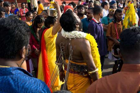 BATU CAVES, MALAYSIA - January 21, 2019: A celebration and devotee carrying kavadi preparing for...