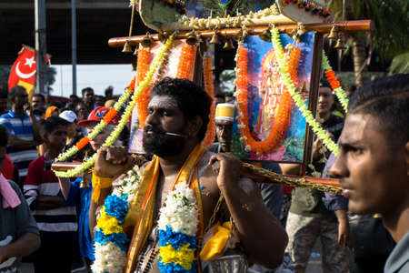 BATU CAVES, MALAYSIA - January 21, 2019: A celebration and devotee carrying kavadi preparing for...
