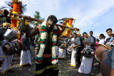 BATU CAVES, MALAYSIA - January 21, 2019: A celebration and devotee carrying kavadi preparing for ceremony prayers blessings during Thaipusam festival.のeditorial素材