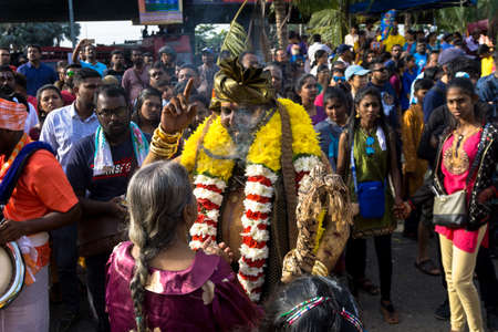 BATU CAVES, MALAYSIA - January 21, 2019: A celebration and devotee carrying kavadi preparing for ceremony prayers blessings during Thaipusam festival. Image contain certain grain or noise and soft focusのeditorial素材