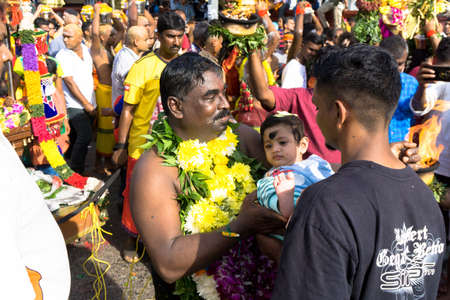 BATU CAVES, MALAYSIA - January 21, 2019: A celebration and devotee carrying kavadi preparing for ceremony prayers blessings during Thaipusam festival.のeditorial素材