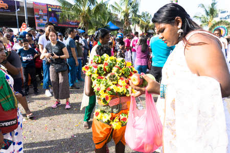 BATU CAVES, MALAYSIA - January 21, 2019: A celebration and devotee carrying kavadi preparing for ceremony prayers blessings during Thaipusam festival.のeditorial素材