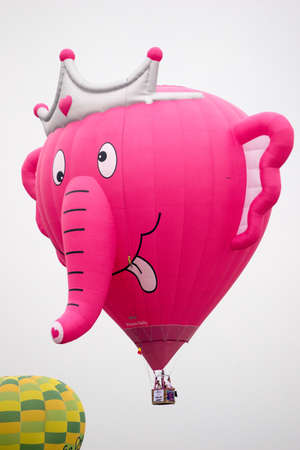 PUTRAJAYA, MALAYSIA - 31 MARCH 2019: The beautiful of multi shaped of hot air balloons floating over sunrise skies at the 10th Putrajaya International Hot Air Balloon Fiesta 2019.のeditorial素材