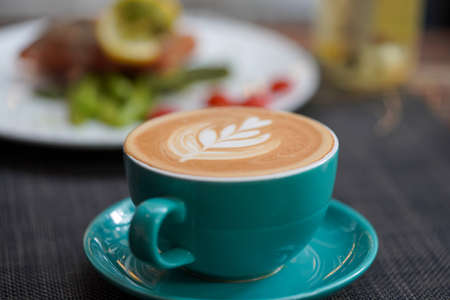 A cup of Coffee Latte on the table.の写真素材