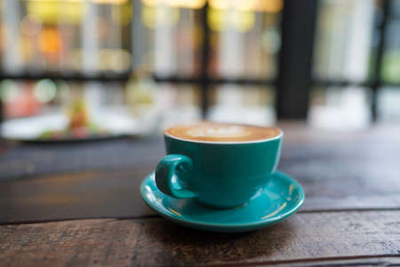 A cup of Coffee Latte on the table.の写真素材