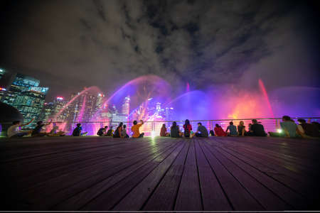 Singapore - February, 2020: Light and Water Show at Event Plaza along promenade in front of Marina Bay Sands. The show of dancing fountains is one of biggest attractions in Singapore by night.のeditorial素材