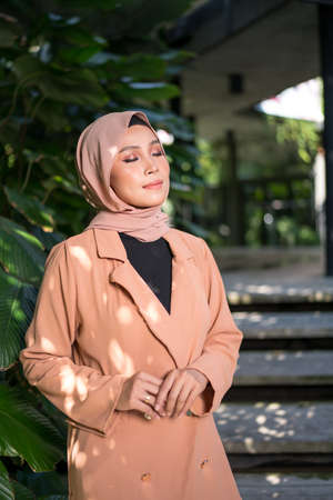 Cyberjaya, Malaysia â 25 December 2019: Fashion portraiture of young beautiful muslim woman wearing hijab.のeditorial素材