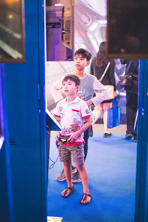 Kuala Lumpur, Malaysia  December, 2019: Boy uses PS4 controller to play video game on PlayStation 4. The PlayStation 4 (PS4) is an eighth-generation home video game console developed by Sony Interactive.のeditorial素材