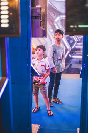 Kuala Lumpur, Malaysia â December, 2019: Boy uses PS4 controller to play video game on PlayStation 4. The PlayStation 4 (PS4) is an eighth-generation home video game console developed by Sony Interactive.のeditorial素材