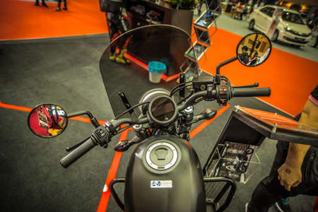 Kuala Lumpur, Malaysia â April 11, 2019 â Car and motocycle displayed at Moto Show in Kuala Lumpur. Exhibitors present most interesting aspects of the automotive industry. The image contains certain grain or noise and soft focus.のeditorial素材