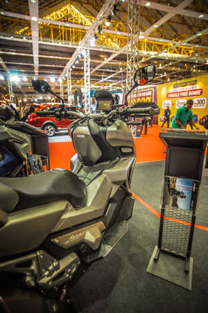 Kuala Lumpur, Malaysia â April 11, 2019 â Car and motocycle displayed at Moto Show in Kuala Lumpur. Exhibitors present most interesting aspects of the automotive industry. The image contains certain grain or noise and soft focus.のeditorial素材