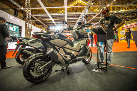 Kuala Lumpur, Malaysia â April 11, 2019 â Car and motocycle displayed at Moto Show in Kuala Lumpur. Exhibitors present most interesting aspects of the automotive industry. The image contains certain grain or noise and soft focus.のeditorial素材