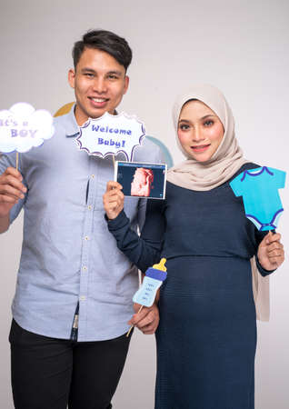 Kuala Lumpur, Malaysia â January, 2020: Handsome man and his beautiful pregnant wife are hugging and smiling.のeditorial素材