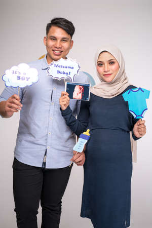 Kuala Lumpur, Malaysia â January, 2020: Handsome man and his beautiful pregnant wife are hugging and smiling.のeditorial素材