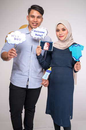Kuala Lumpur, Malaysia â January, 2020: Handsome man and his beautiful pregnant wife are hugging and smiling.のeditorial素材
