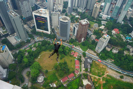 Kuala Lumpur, Malaysia â September 29, 2018: Base Jumpers landed from a 300m high deck during the Kuala Lumpur Tower International Jump.のeditorial素材