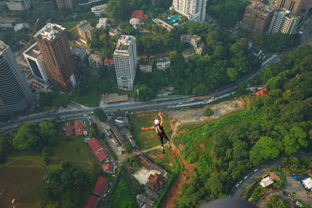 Kuala Lumpur, Malaysia â September 29, 2018: Base Jumpers landed from a 300m high deck during the Kuala Lumpur Tower International Jump.のeditorial素材