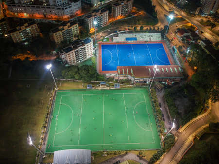 Aerial birdâs eye view of the outdoor hockey field at night. The image contains soft-focus, grain, and noise.のeditorial素材