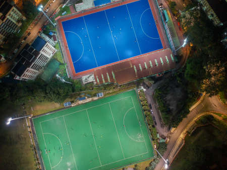 Aerial birdâs eye view of the outdoor hockey field at night. The image contains soft-focus, grain, and noise.のeditorial素材