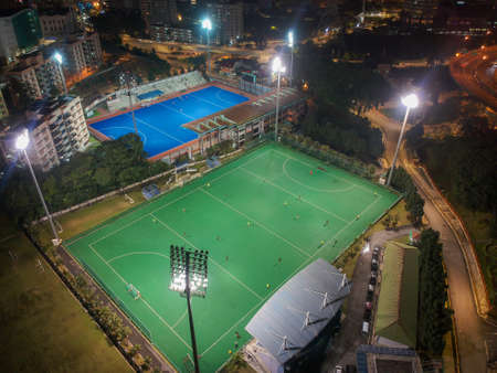 Aerial birdâs eye view of the outdoor hockey field at night. The image contains soft-focus, grain, and noise.のeditorial素材