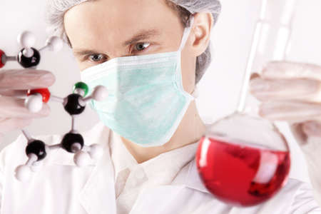 Scientist Holding Flask and Atomsの写真素材