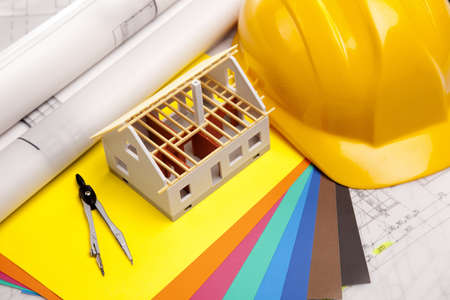 Construction plans with helmet and drawing tools on blueprintsの写真素材