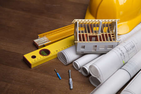 Construction plans with helmet and drawing tools on blueprintsの写真素材