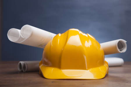 Construction plans with helmet and drawing tools on blueprintsの写真素材