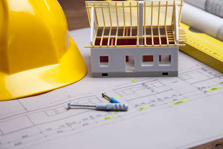 Construction plans and blueprints on wooden tableの写真素材