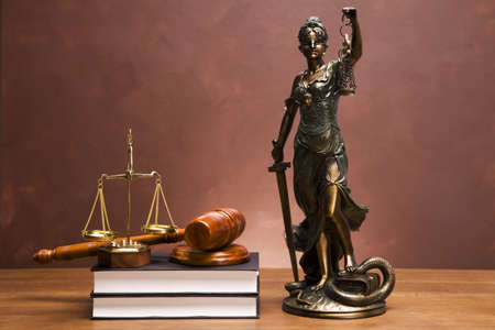 Gavel of justice and gavel on desk with dark backgroundの写真素材