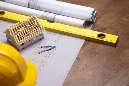 Construction plans and blueprints on wooden table