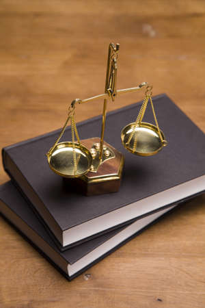 Scales of justice and gavel on desk with dark backgroundの写真素材