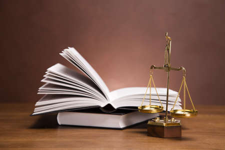 Scales of justice and gavel on desk with dark backgroundの写真素材