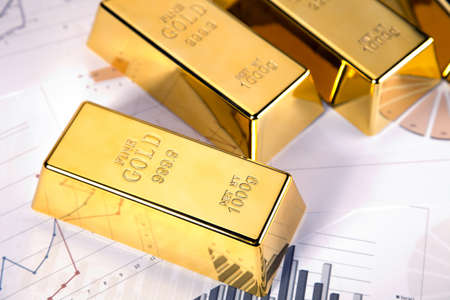 gold bars on graphs and statistics, studio shots, closeup