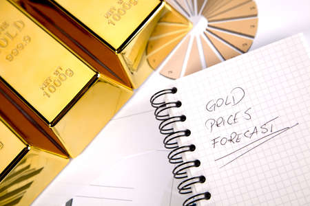 Photo of gold bars on graphs and statistics, studio shots, closeupの写真素材