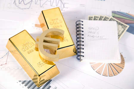 Photo of gold bars on graphs and statistics, studio shots, closeupの写真素材