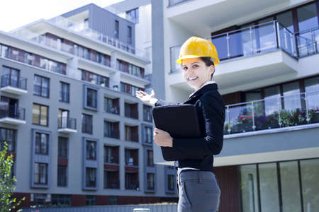 Female construction engineer show building in backgroundの写真素材