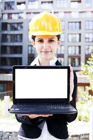 Female construction engineer show something on laptopの写真素材