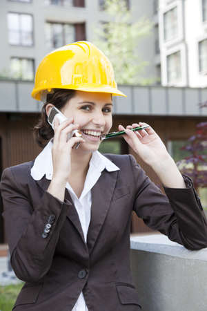 Young female construction engineer with phoneの写真素材