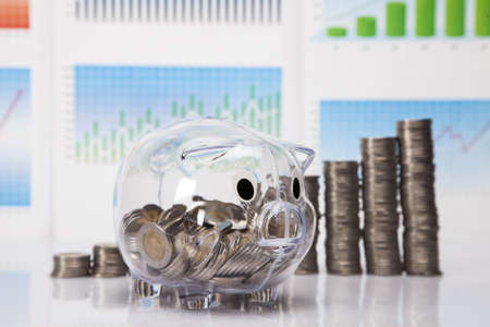 Savings in piggy bank  A lot of money  Isolated on white background の写真素材