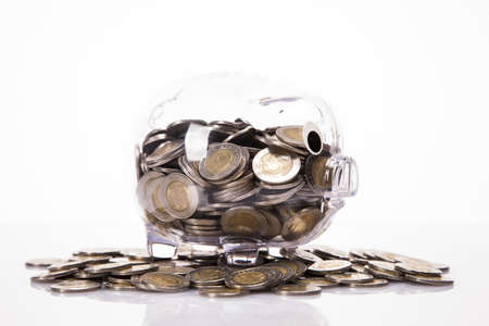 Savings in piggy bank  A lot of money  Isolated on white background の写真素材