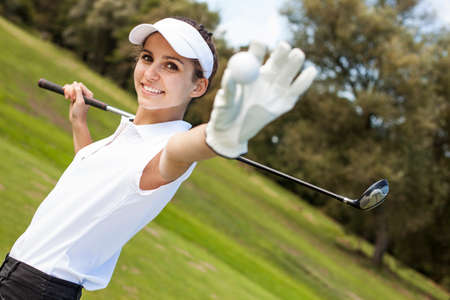 Portrait of a woman playing golf in summer