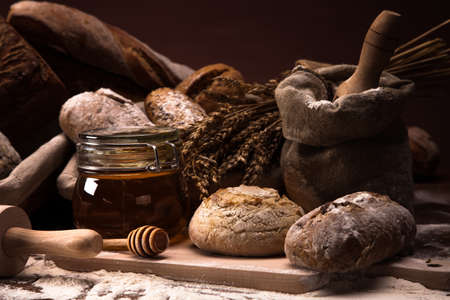 Fresh bread and wheat on the wooden table