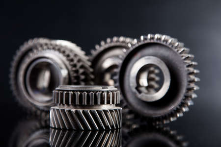 Big metal gears on glossy black backgroundの写真素材